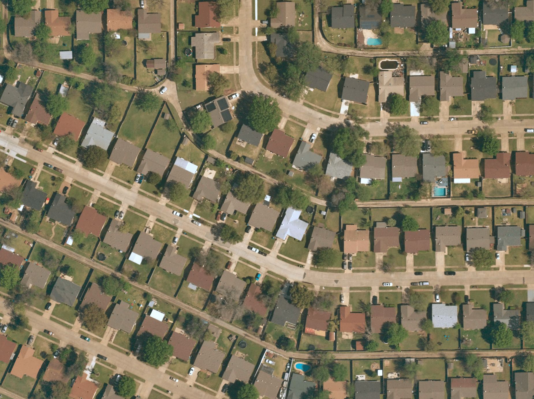 Near Space Labs' 10 cm image of a neighborhood showing property details such as solar panels, swimming pools, and surrounding foliage.