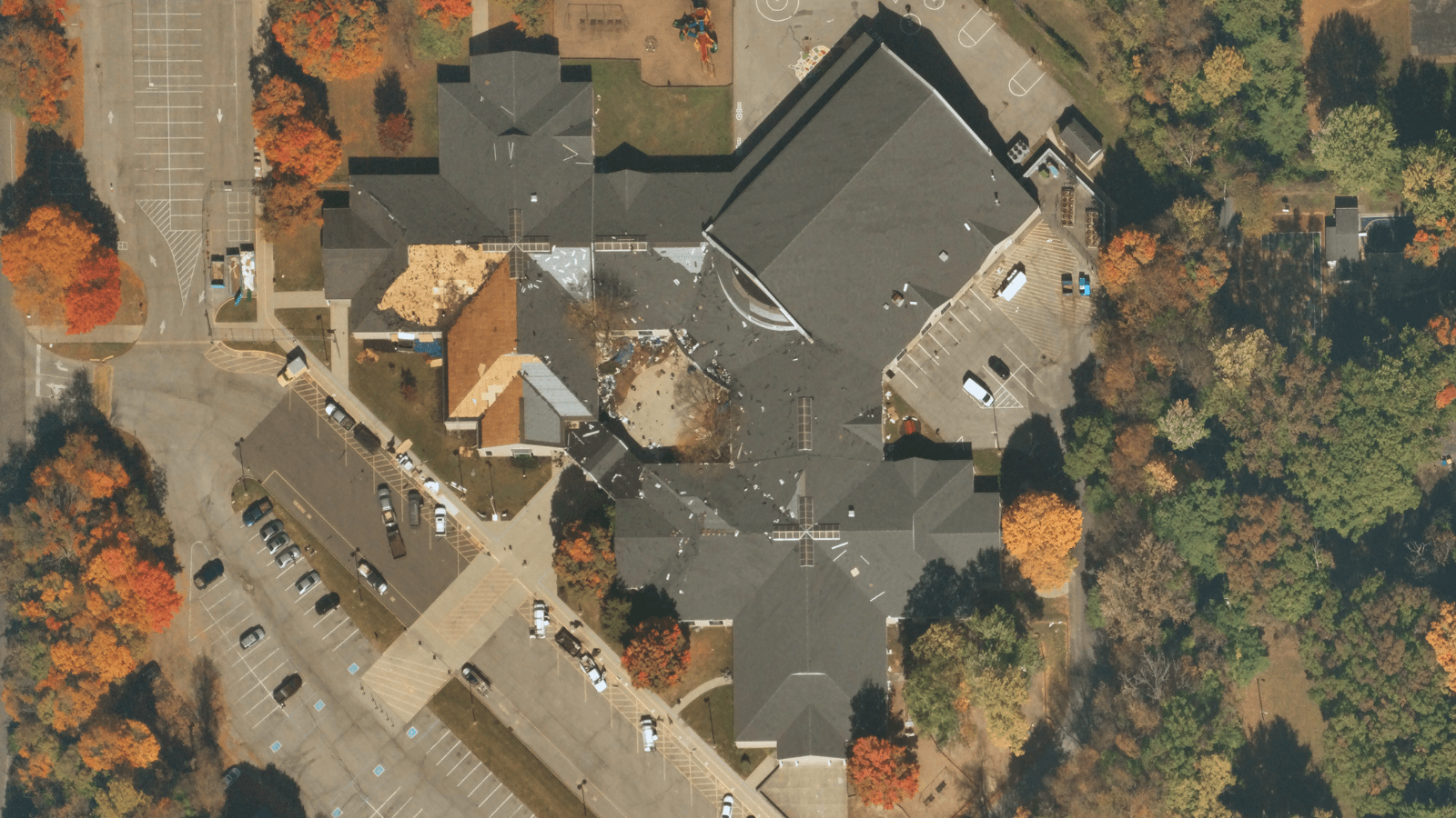 Near Space Labs 10 cm image of building undergoing roof replacement due to missing shingles.