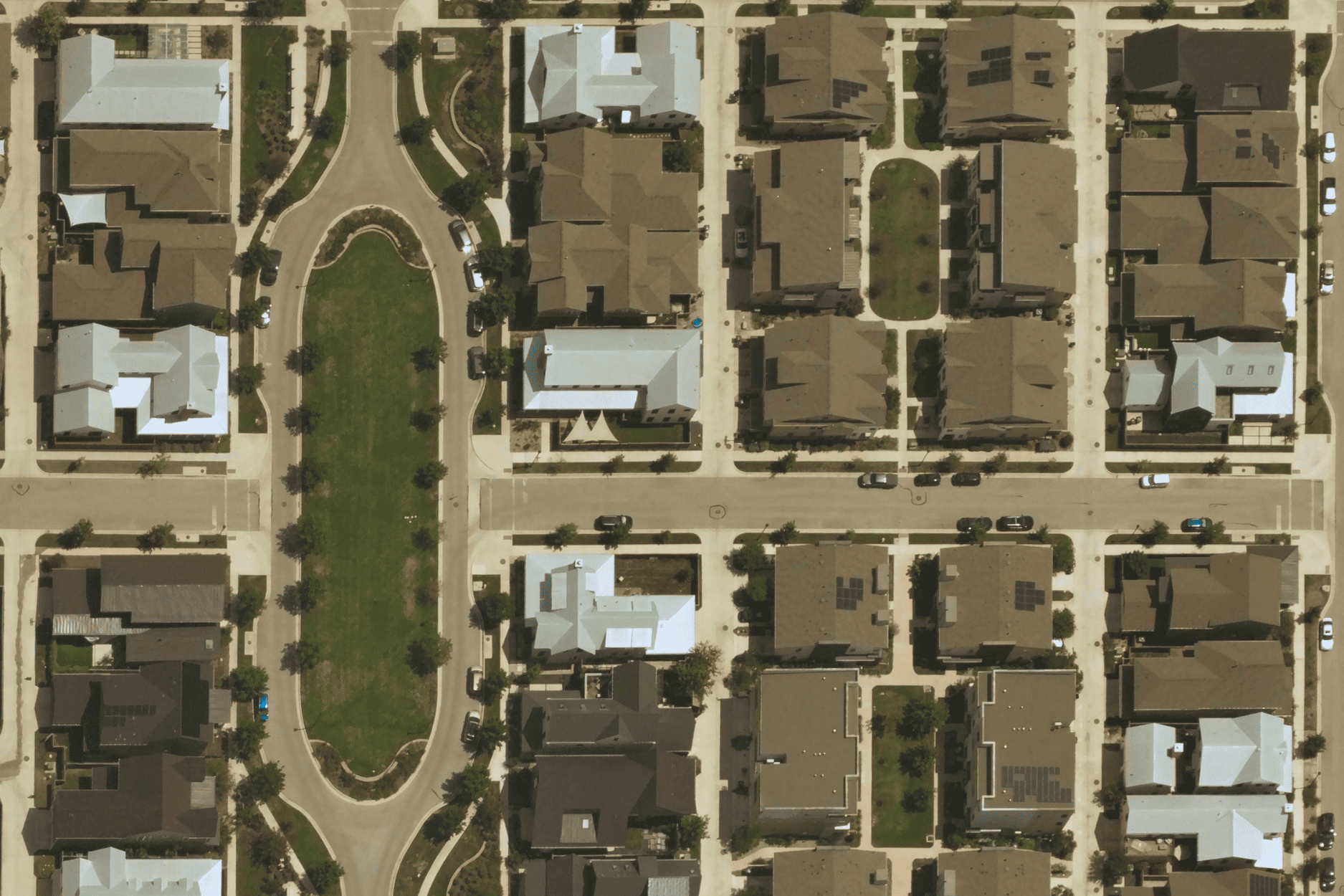 Near Space Labs' 10 cm image of neighborhood showing houses with more resilient metal roofs.